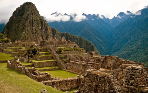 The Peru Wallpapers feature Machu Picchu ruins with green terraces and mountains under cloudy sky, 2K Desktop Wallpaper