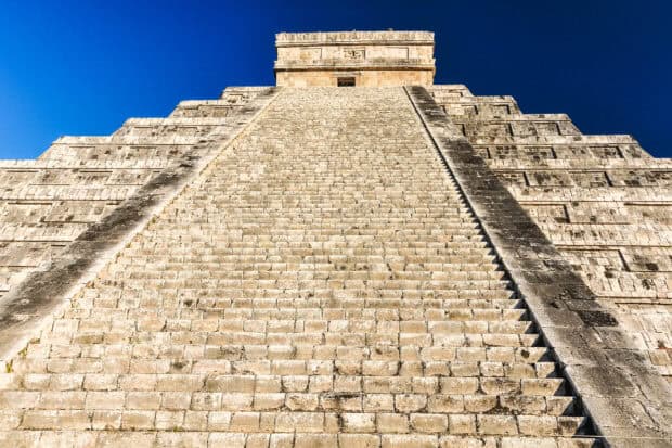 The ancient Mayan pyramid at Chichen Itza stands tall under a clear blue sky, 2K Desktop Wallpaper