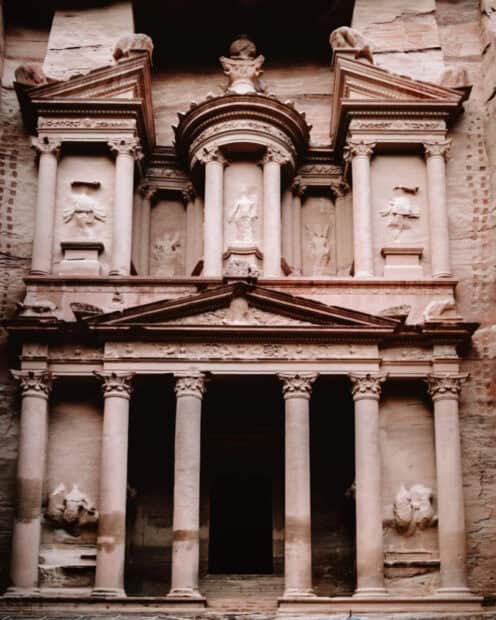 The ancient Petra Jordan structure features carved stone columns and detailed facades, HD Mobile Wallpaper