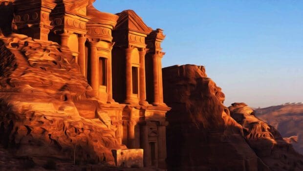 The ancient Petra Jordan architecture glows warmly under the clear sky, 4K Desktop Wallpaper
