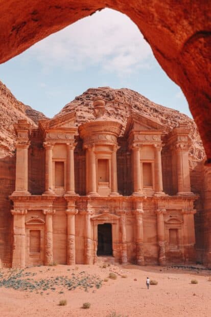 A person walks near the ancient carved stone structure in Petra Jordan, HD Mobile Wallpaper