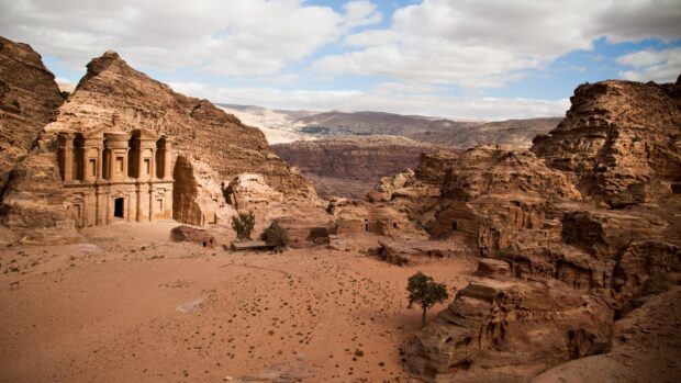 The ancient city of Petra carved into rocky cliffs surrounded by desert hills is a famous Petra Jordan Wallpapers site, 2K Desktop Wallpaper