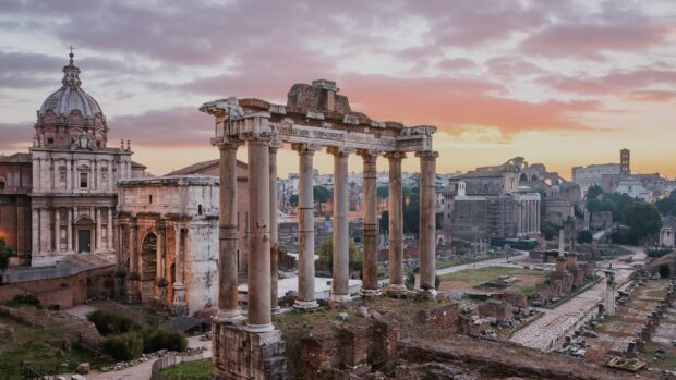 The Rome skyline features ancient ruins and historic buildings under a colorful sunset sky, 4K Desktop Wallpaper