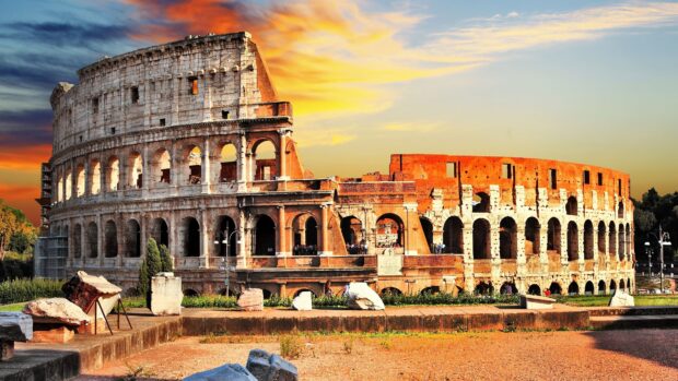 The Rome skyline shows the ancient Coliseum at sunset with vibrant sky colors, 4K Desktop Wallpaper