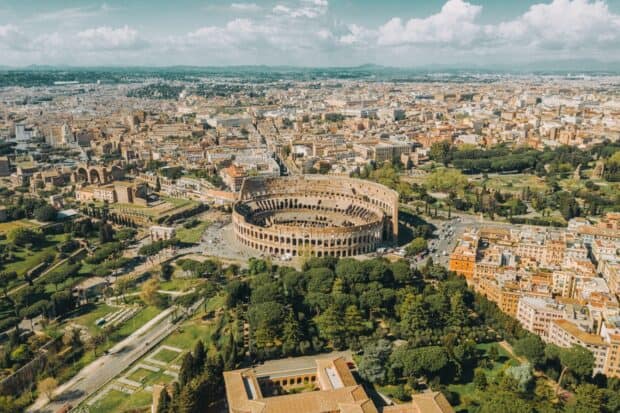 A panoramic view of Rome featuring the Colosseum and city skyline, HD Desktop Wallpaper