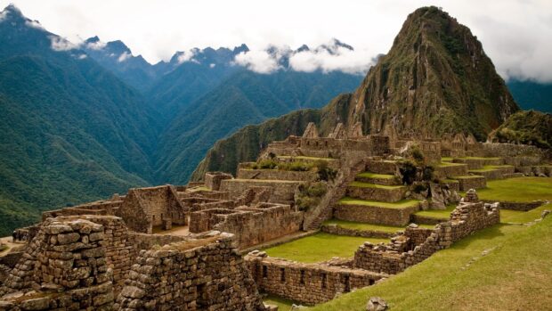 The ancient ruins of Peru stand against a backdrop of misty mountains and green terraces, HD Desktop Wallpaper