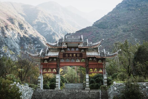 A traditional gate stands against mountain scenery in the Tibetan Highlands, HD Desktop Wallpaper