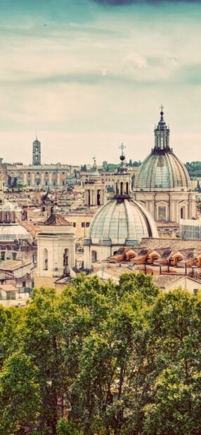 The Rome skyline showcases historic domes and buildings surrounded by lush greenery under a cloudy sky, 2K Phone Wallpaper