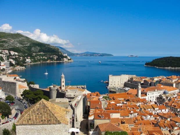 The ancient city walls of Dubrovnik overlook the Adriatic Sea with historic rooftops, HD Desktop Wallpaper