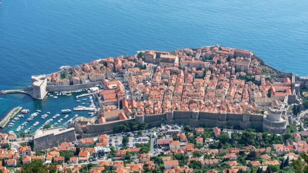 Aerial view of ancient city walls of Dubrovnik surrounded by the sea, 4K Desktop Wallpaper