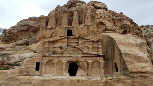 Jordan, The ancient rock cut structure in Petra, Jordan showcases detailed carvings and openings, 2K Desktop Wallpaper