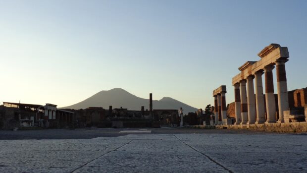 A view of Pompeii ruins with Mount Vesuvius in the background during sunrise, 4K Desktop Wallpaper