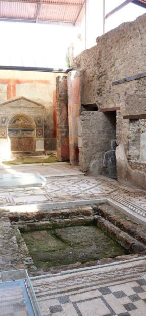 The Pompeii ruins showcase detailed mosaics and stone walls in an indoor area, 2K Mobile Wallpaper