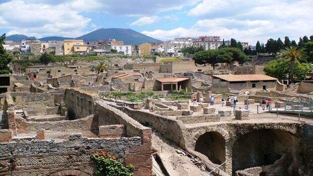 The image shows the ancient ruins and structures of Pompeii with Mount Vesuvius in the background, HD Desktop Wallpaper