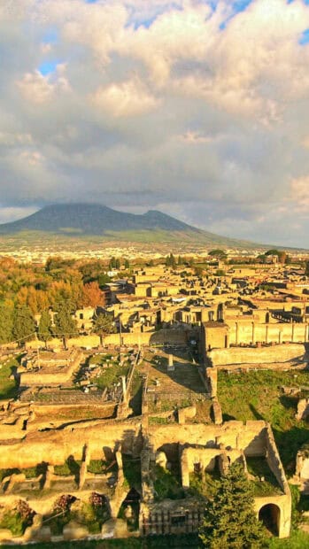 The Pompeii ruins showcase the ancient city with Mount Vesuvius in the background, HD Mobile Wallpaper