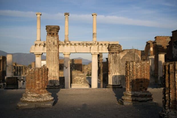 The Pompeii ruins showcase ancient columns and structures under clear sky, 2K Desktop Wallpaper