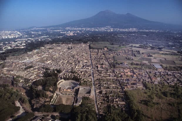 The Pompeii ruins stretch under Mount Vesuvius showcasing history and architecture, HD Desktop Wallpaper
