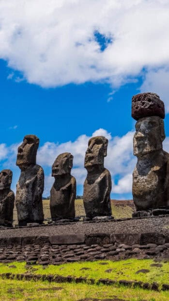 The Easter Island statues stand tall against a bright blue sky with clouds, HD Phone Wallpaper