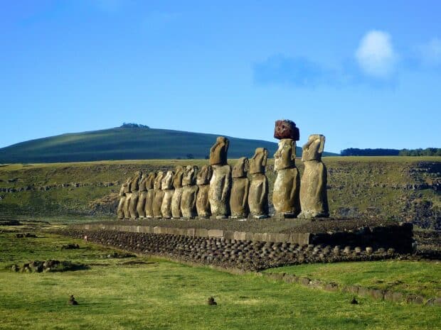 A row of iconic Easter Island statues stands under a clear blue sky, 2K Desktop Wallpaper