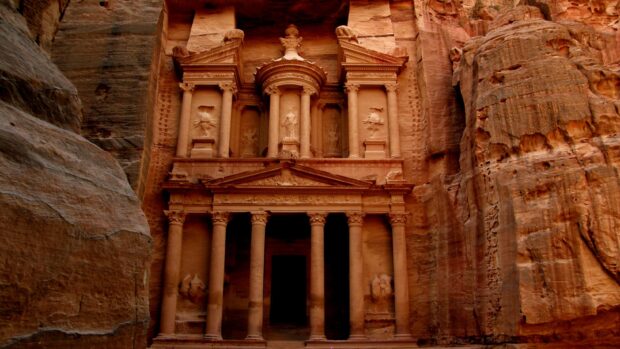 The ancient stone facade stands carved in the cliffs of Petra Jordan showcasing impressive architecture, 2K Desktop Wallpaper