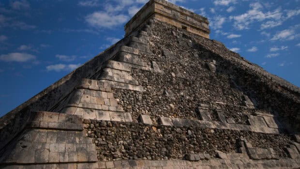 The ancient stone pyramid of Chichen Itza stands under a clear blue sky, 2K Desktop Wallpaper