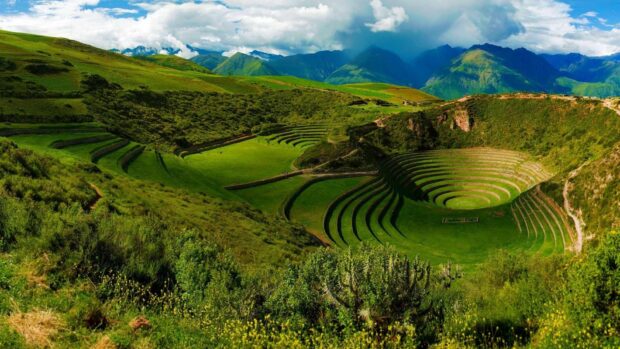 The Peru terraces are surrounded by green hills under a cloudy sky, HD Desktop Wallpaper