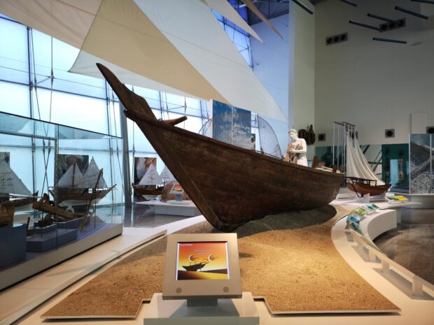 An ancient wooden boat is displayed in the maritime museum showcasing traditional shipbuilding, HD Desktop Wallpaper