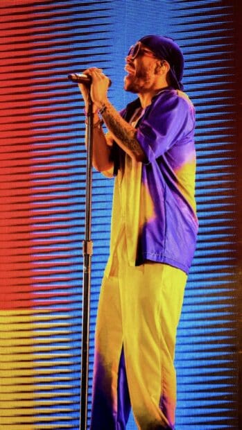 Anderson Paak is singing passionately on stage with colorful lights, HD Mobile Wallpaper