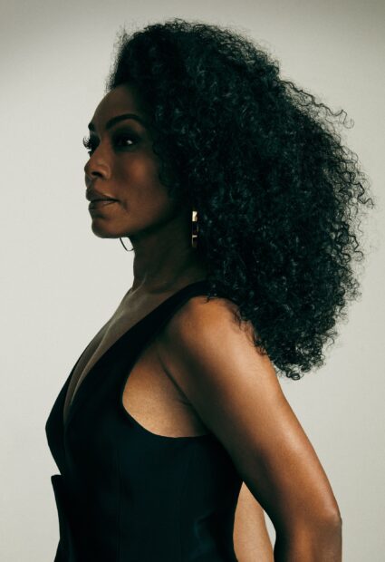 Angela Bassett stands confidently with curly hair and earrings, 2K Phone Wallpaper