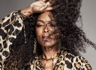 Angela Bassett with voluminous curly hair posing wearing a leopard print blouse, 2K Desktop Wallpaper