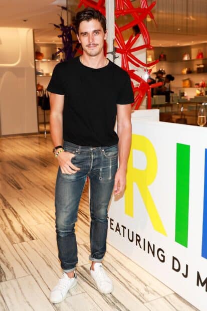 Antoni Porowski is standing indoors wearing a black t shirt and jeans, HD Mobile Wallpaper