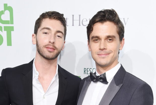 Antoni Porowski poses with a friend wearing formal suits at an event, HD Desktop Wallpaper