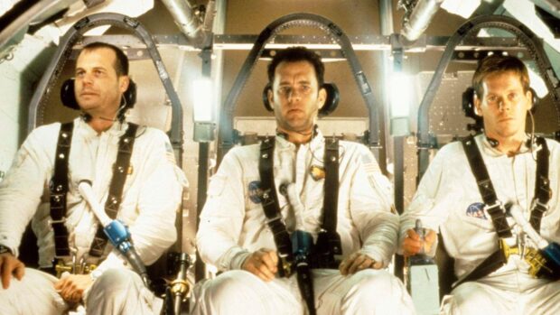 The Apollo 13 crew is seated inside the spacecraft wearing space suits and headsets during their mission, HD Desktop Wallpaper
