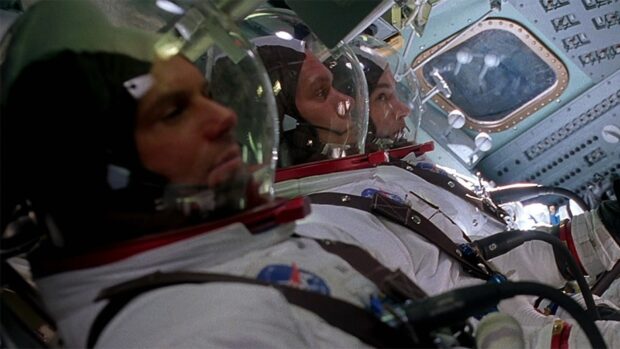 The Apollo 13 crew is seated inside the spacecraft wearing space suits and helmets, HD Desktop Wallpaper
