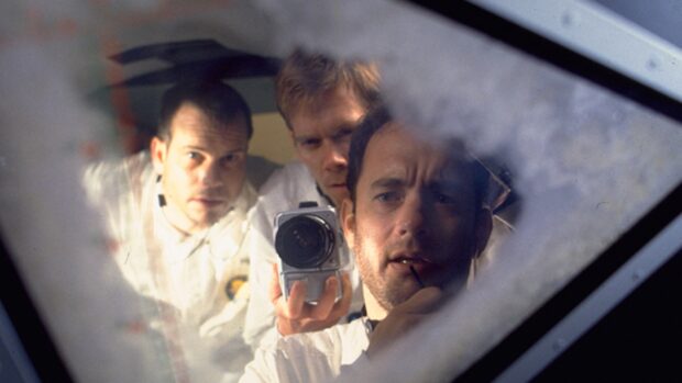 The Apollo 13 crew is seen taking a photo inside the spacecraft reflecting their focused expressions during the mission, HD Desktop Wallpaper