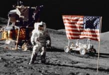 An astronaut stands on the moon with a flag and lunar module, HD Desktop Wallpaper