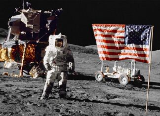 An astronaut stands on the moon with a flag and lunar module, HD Desktop Wallpaper