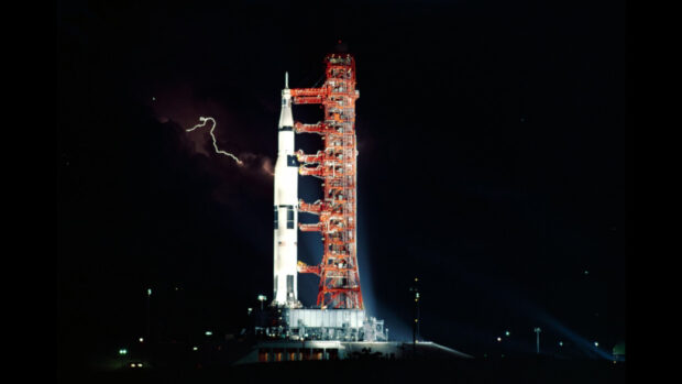 The Apollo 13 rocket stands on the launch pad with lightning in the night sky, HD Desktop Wallpaper