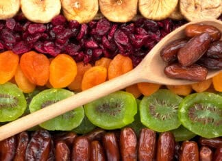 A wooden spoon with dates lies on a variety of dried apricots and fruits, HD Desktop Wallpaper
