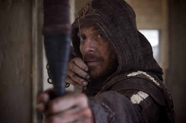 A close up of a hooded archer aiming his bow in Assassins Creed movie, 2K Desktop Wallpaper