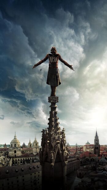 A character from Assassins Creed movie stands on a cathedral spire overlooking the city, 2K Phone Wallpaper