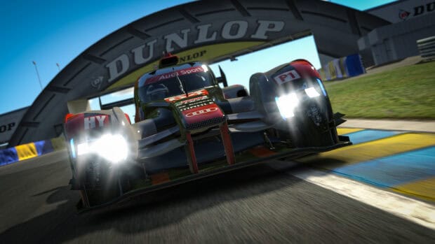 Intense racing game action with illuminated headlights on track, HD Desktop Wallpaper