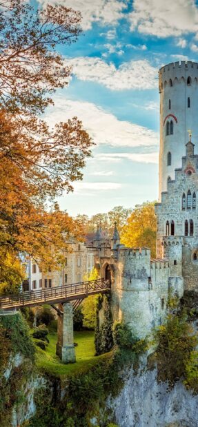A beautiful autumn castle scene with trees and a bridge in Liechtenstein Wallpapers, 2K Mobile Wallpaper