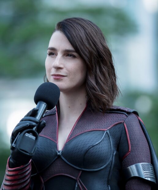 Aya Cash speaks into a microphone while wearing a superhero suit, HD Desktop Wallpaper