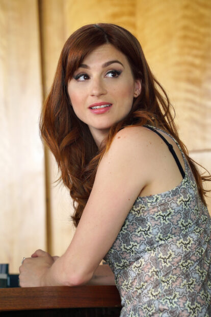 Aya Cash appears seated with a patterned dress and red hair in this portrait, 2K Mobile Wallpaper