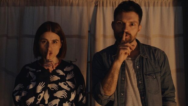 Aya Cash with a man both showing silence gesture in dim light, HD Desktop Wallpaper