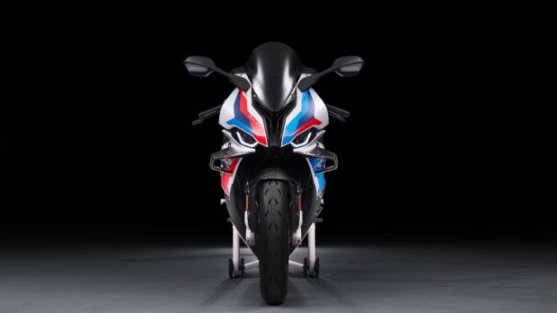 The BMW M 1000 RR is shown front facing with racing decals on a dark background, 4K Desktop Wallpaper