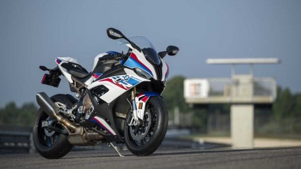 A BMW M 1000 RR stands on a road with a clear sky background, HD Desktop Wallpaper