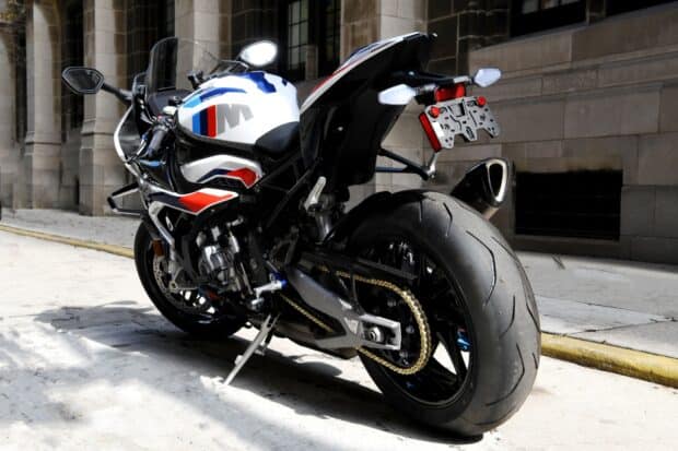 A close up view of a BMW M 1000 RR motorcycle parked on a city street, HD Desktop Wallpaper