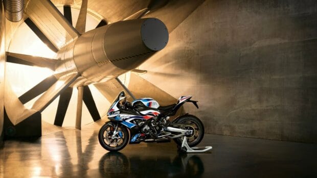 BMW M 1000 RR positioned in a large wind tunnel with industrial lighting, HD Desktop Wallpaper